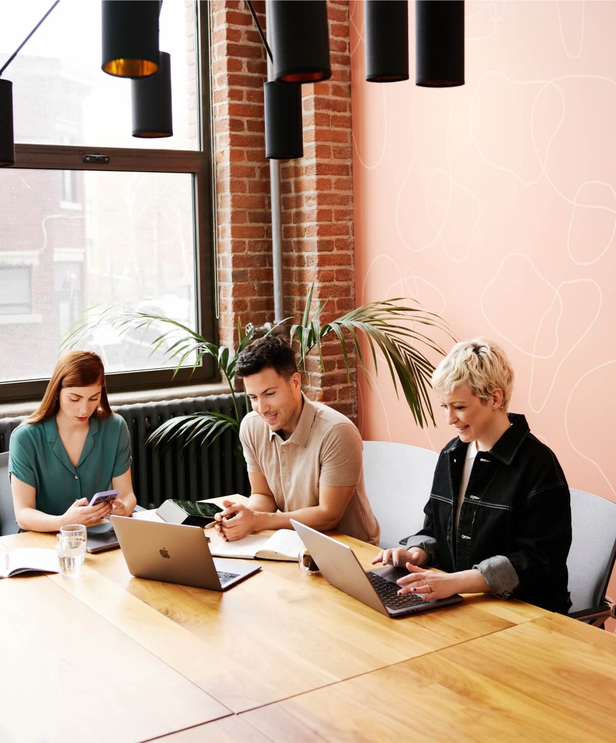 Collaborative career development: Woman interacting with her managers in a conference room, representing teamwork and professional growth